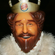 A close-up of the creepy Burger King mascot's shiny plastic face.